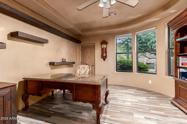 a patio with table and chairs and potted plants