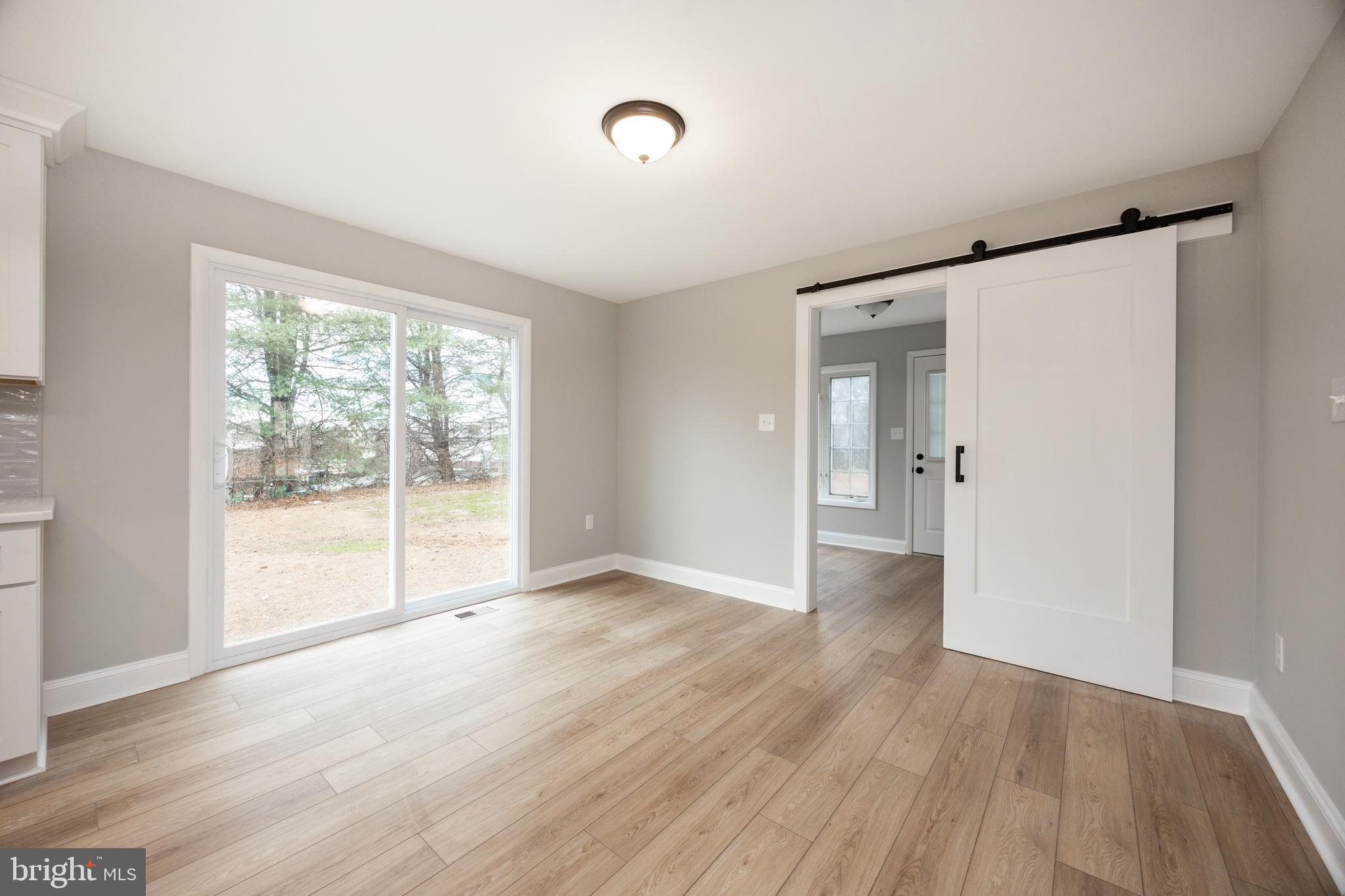 60 Buckwalter Road Royersford, PA 19468 - Photo 12 of 40 a view of an empty room with wooden floor and a window