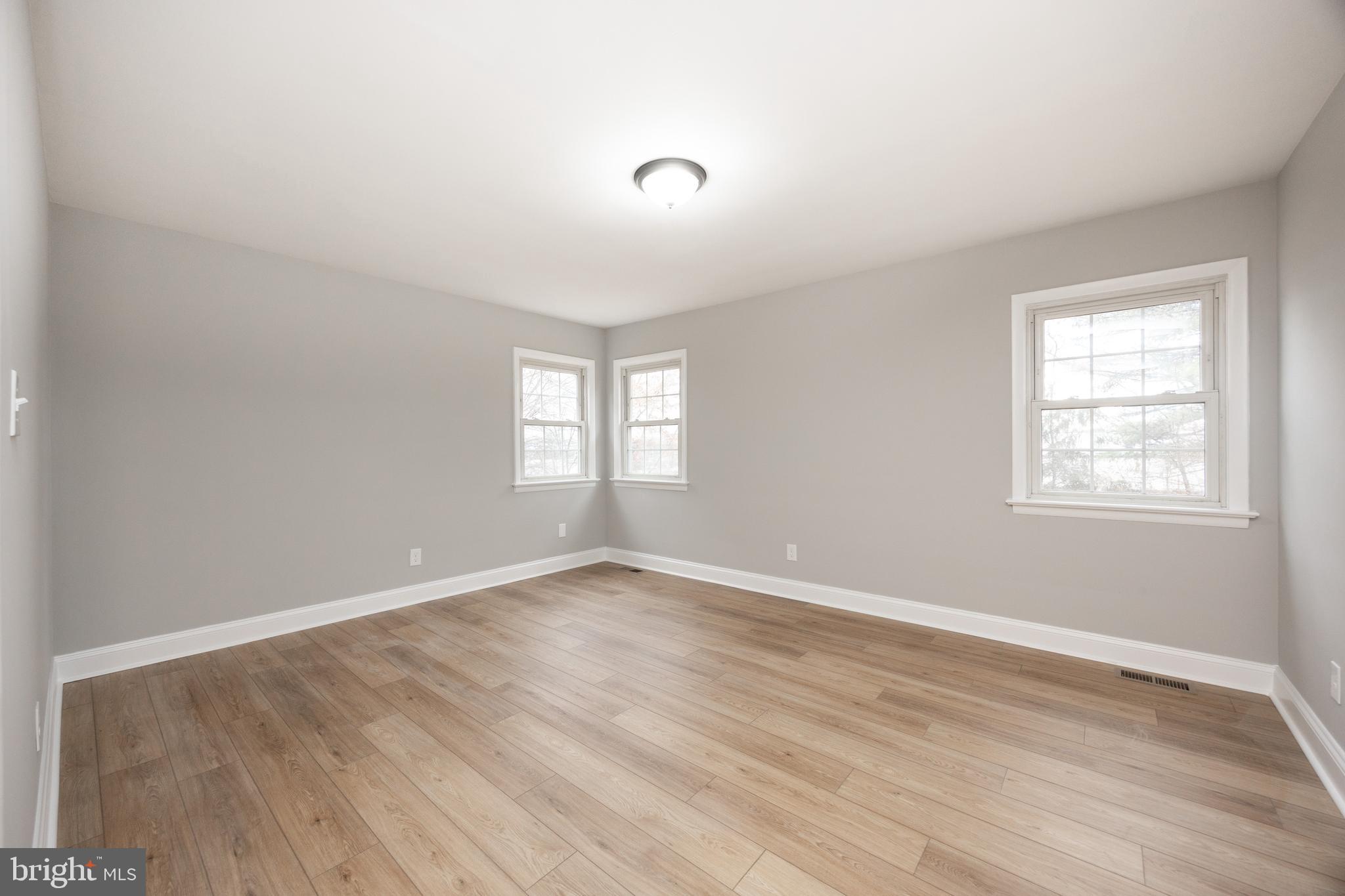 60 Buckwalter Road Royersford, PA 19468 - Photo 13 of 40 an empty room with wooden floor and windows