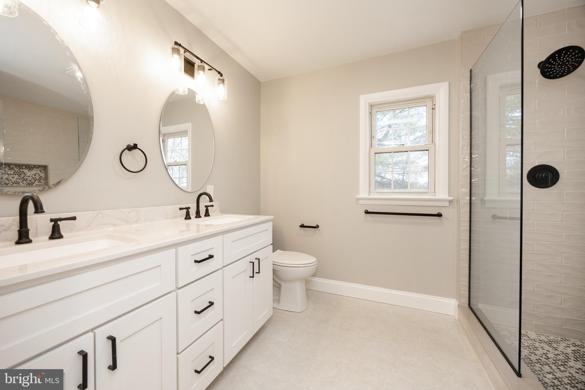 60 Buckwalter Road Royersford, PA 19468 - Photo 15 of 40 a spacious bathroom with a double vanity sink a mirror and a toilet