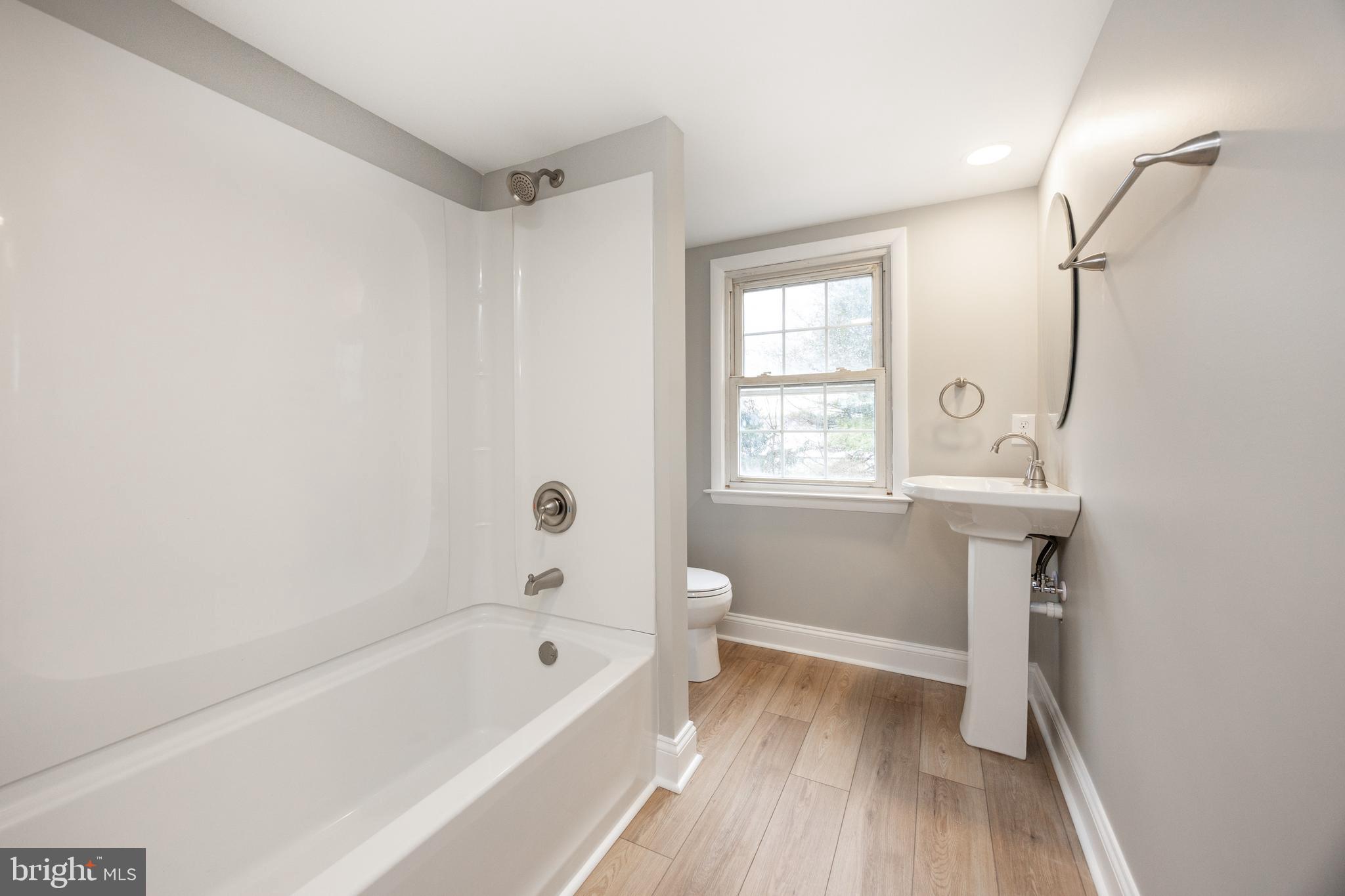 60 Buckwalter Road Royersford, PA 19468 - Photo 32 of 40 a bathroom with a bathtub a sink and a window