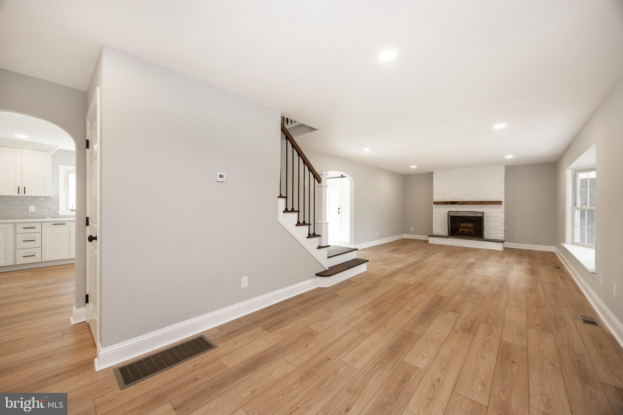 60 Buckwalter Road Royersford, PA 19468 - Photo 4 of 40 an empty room with wooden floor and a fireplace