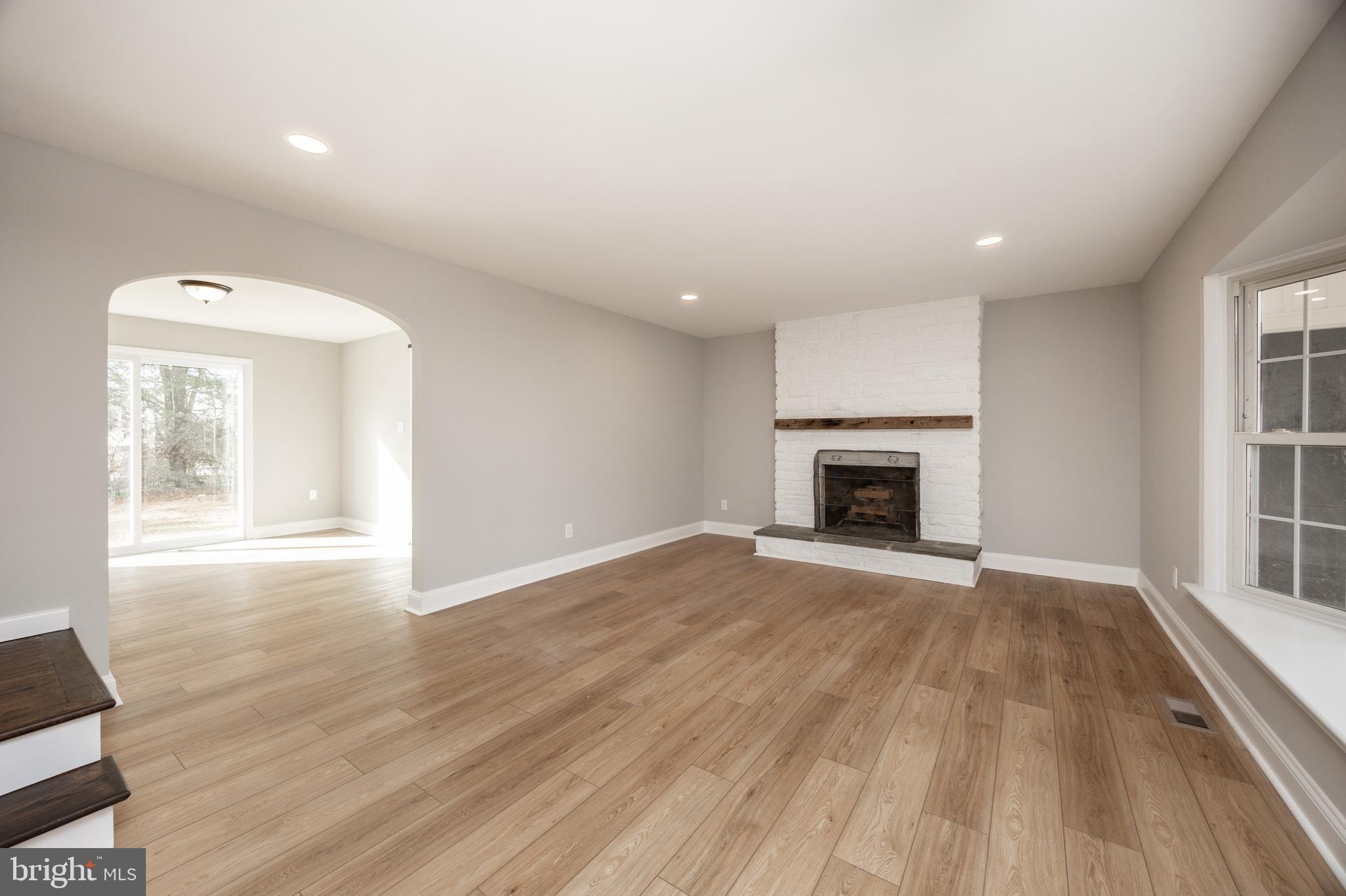 60 Buckwalter Road Royersford, PA 19468 - Photo 6 of 40 an empty room with wooden floor a fireplace and windows