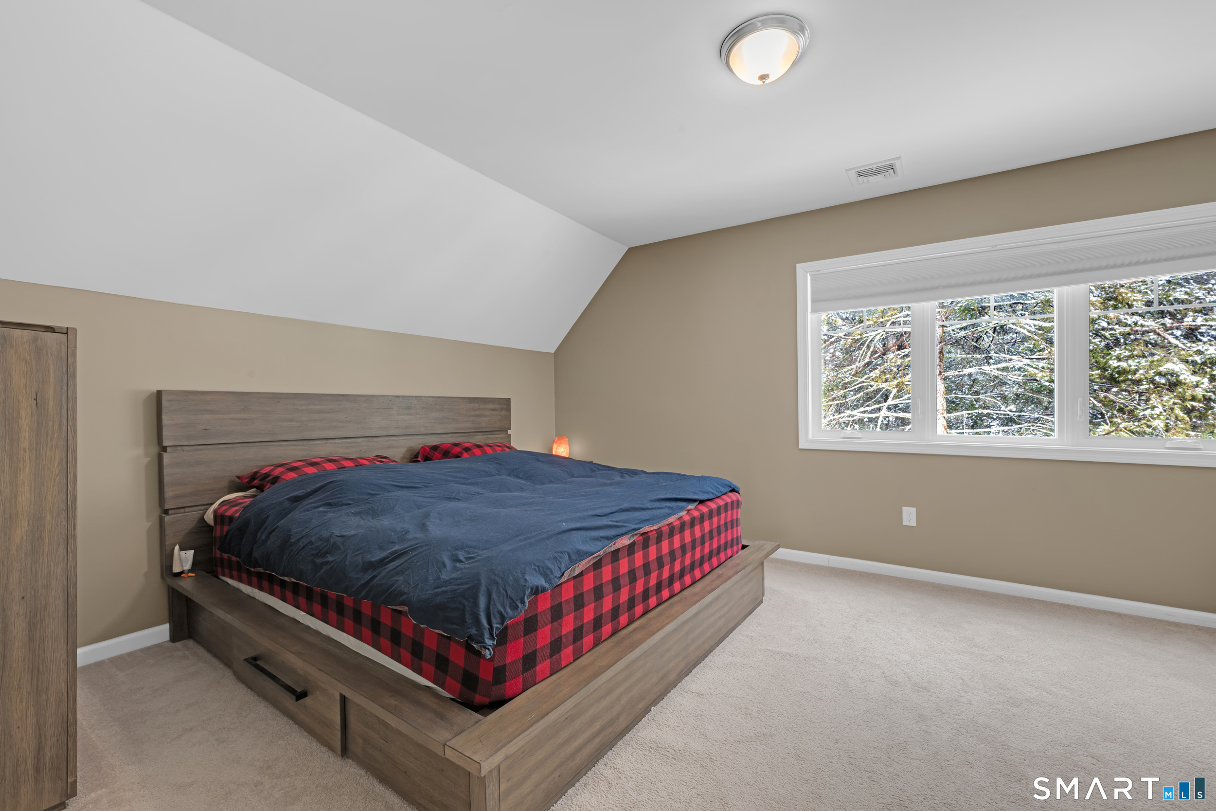 123 Ashford Road, Unit 1 Eastford, CT 06242 - Photo 13 of 23 a bed sitting in a bedroom next to a window