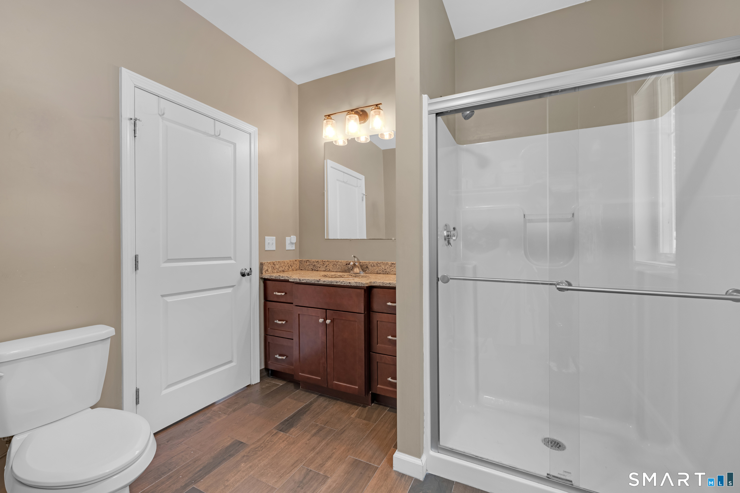 123 Ashford Road, Unit 1 Eastford, CT 06242 - Photo 20 of 23 a bathroom with a granite countertop sink toilet and shower