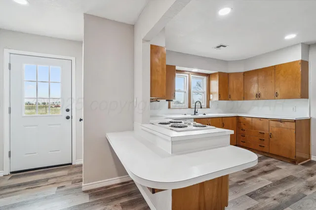 a kitchen with a sink appliances and cabinets