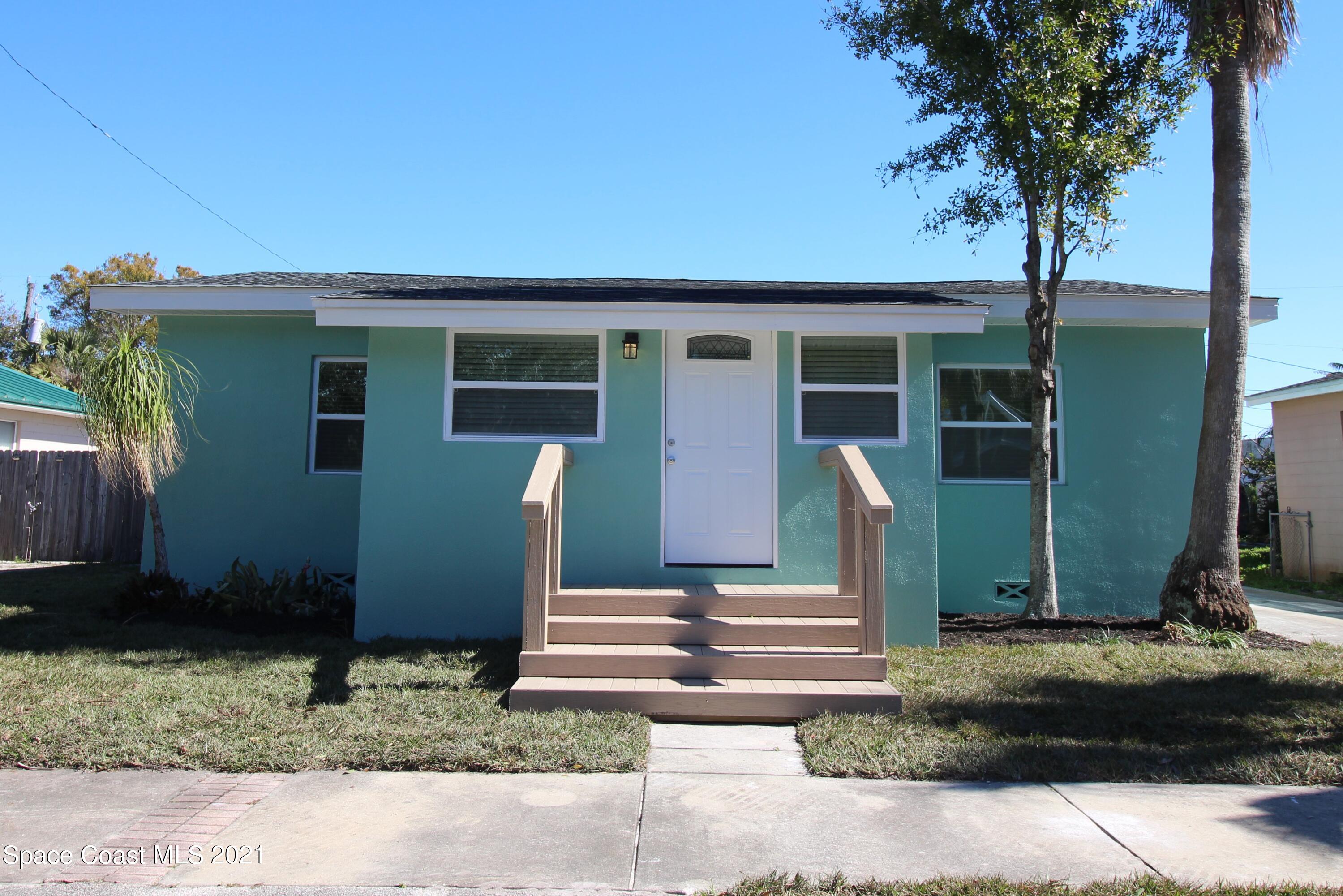 244 North Grove Street Merritt Island, FL 32953 - Photo 1 of 25 a front view of a house with garden