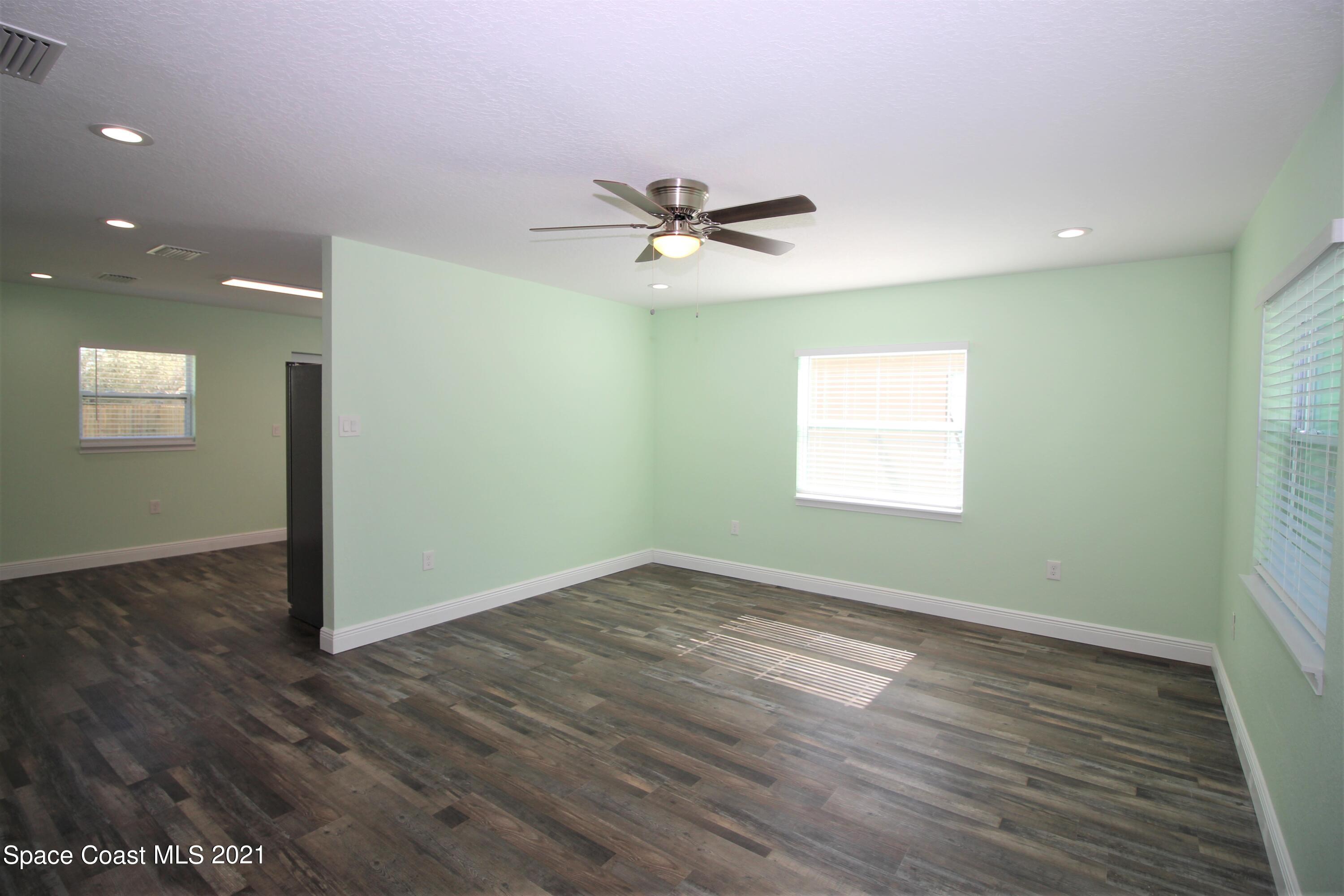 244 North Grove Street Merritt Island, FL 32953 - Photo 6 of 25 wooden floor in an empty room with a window