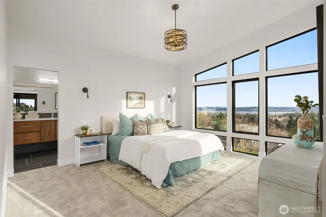 a bedroom with a bed and a large window