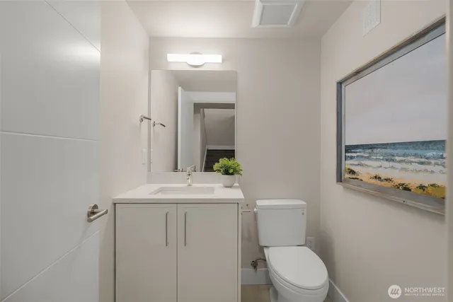 a bathroom with a window sink and mirror