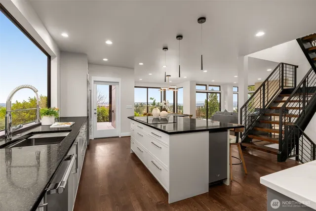 a kitchen with counter top space and wooden floor