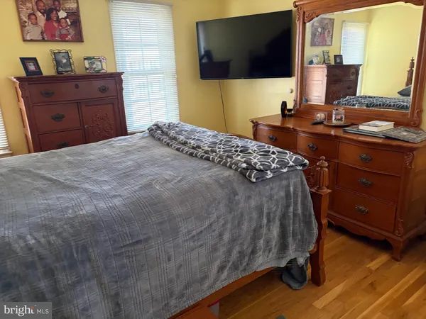 a bedroom with a bed and flat screen tv