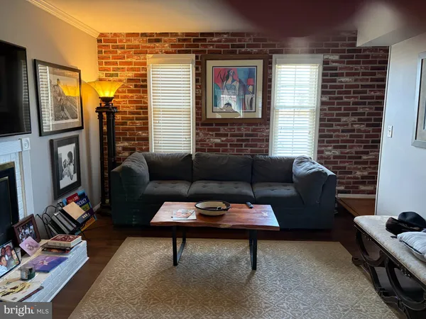 a living room with furniture a rug and a window
