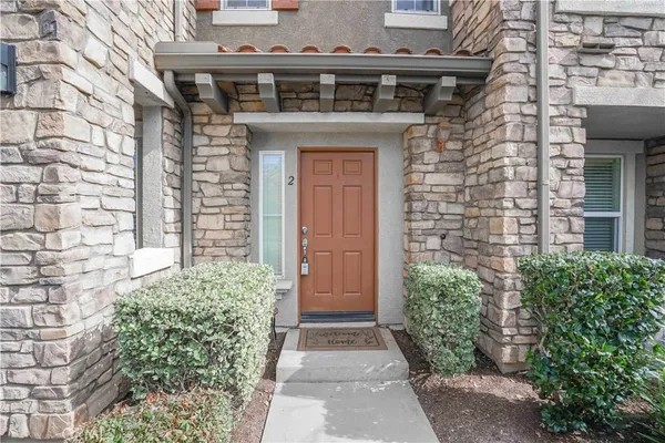 front view of a brick house with a large windows