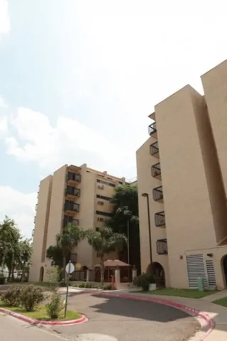 a tall building sitting next to a yard