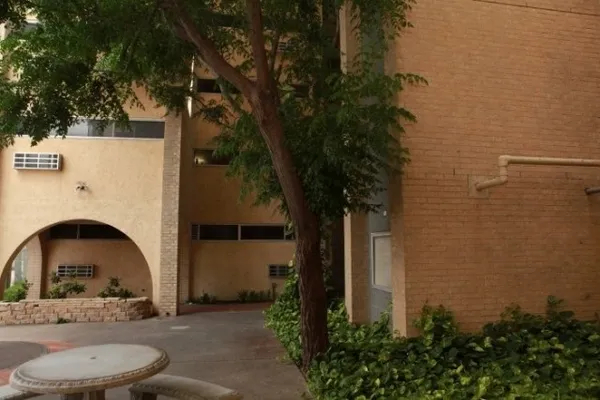 a view of house with yard and trees around
