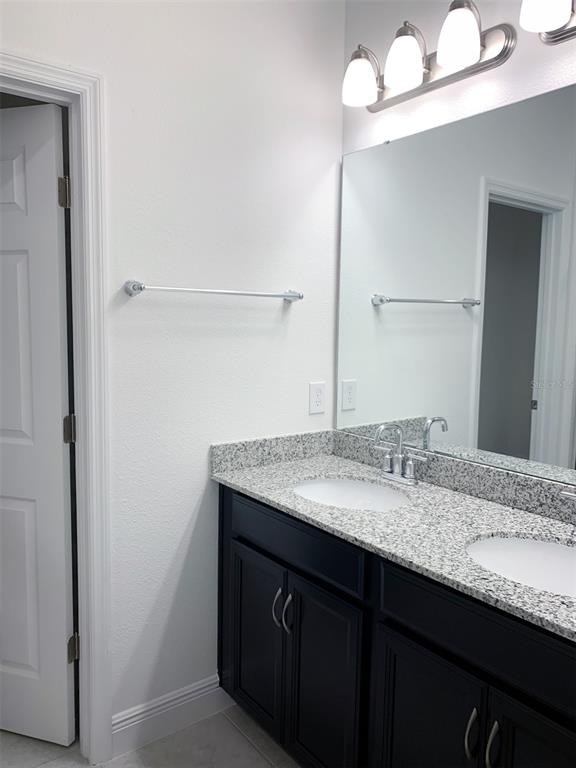 1480 Broad Wing Lane Winter Park, FL 32792 - Photo 12 of 17 a bathroom with a granite countertop sink and a mirror