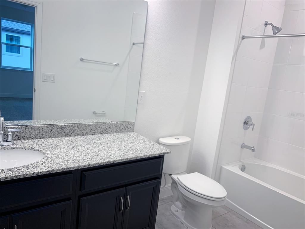 1480 Broad Wing Lane Winter Park, FL 32792 - Photo 9 of 17 a bathroom with a granite countertop sink toilet and shower