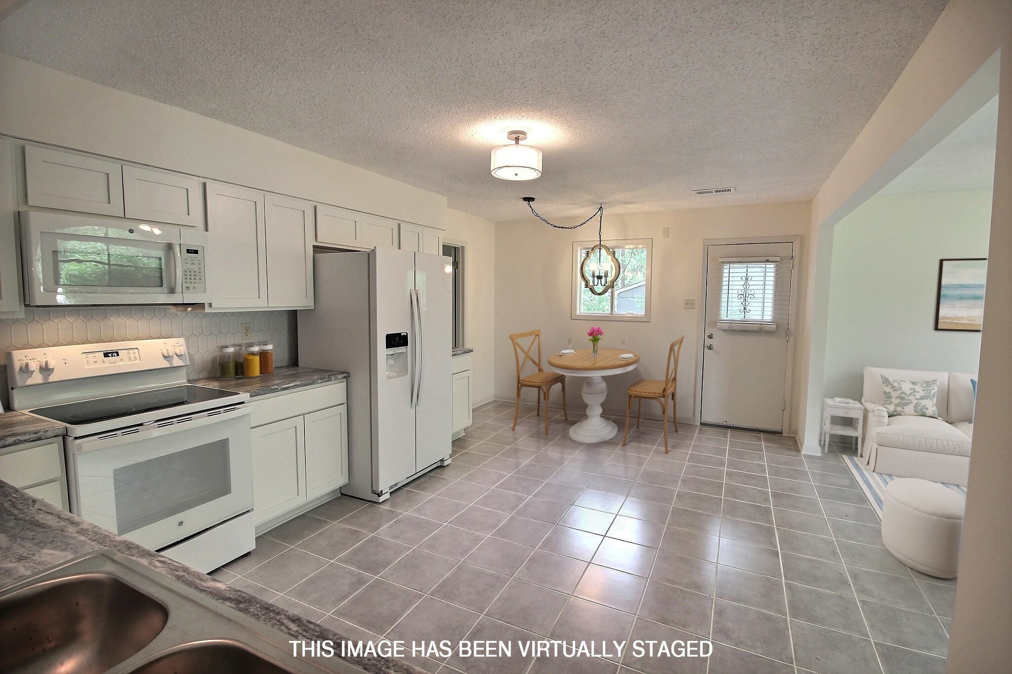 943 Poplar Leaf Road Collierville, TN 38017 - Photo 14 of 17 a large white kitchen with a stove a sink dishwasher and a refrigerator
