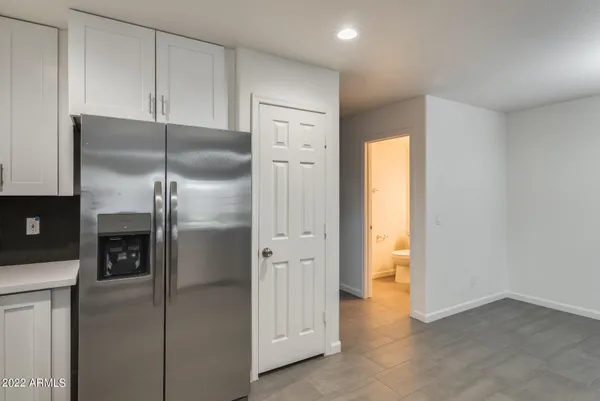 a kitchen with a refrigerator and a refrigerator