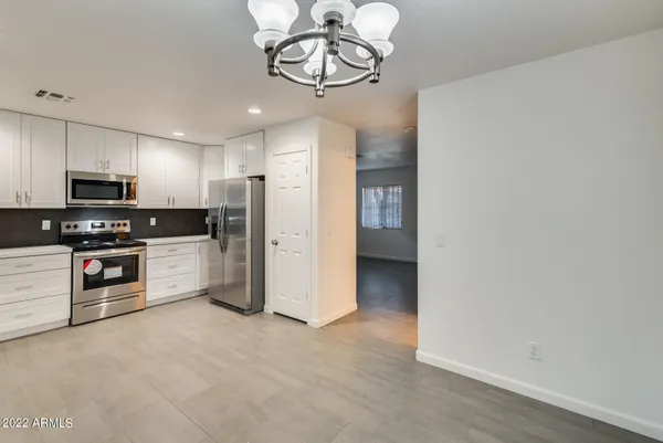 a kitchen with stainless steel appliances a refrigerator and a stove top oven