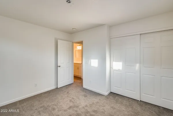 an empty room with closet area
