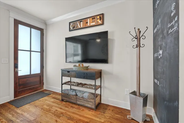 a living room with furniture and a flat screen tv
