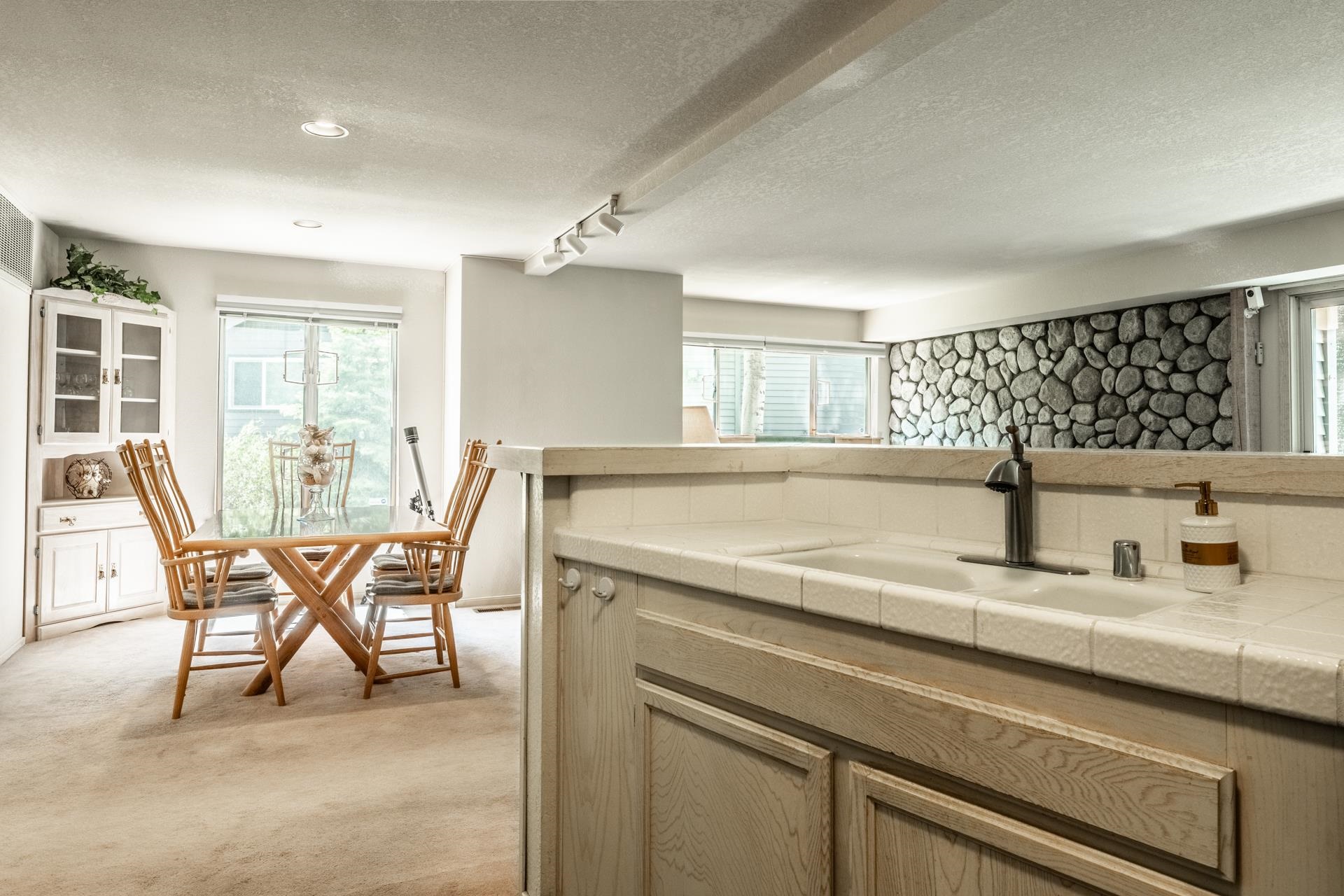 609 Golden Creek Road, Unit 609 Mammoth Lakes, CA 93546 - Photo 25 of 42 Wet bar featuring a tile countertop, integrated sink, and wood-finish cabinetry