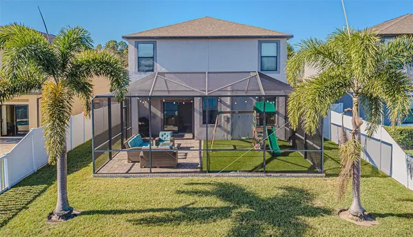 a living room with stainless steel appliances kitchen island granite countertop a stove a sink and a microwave