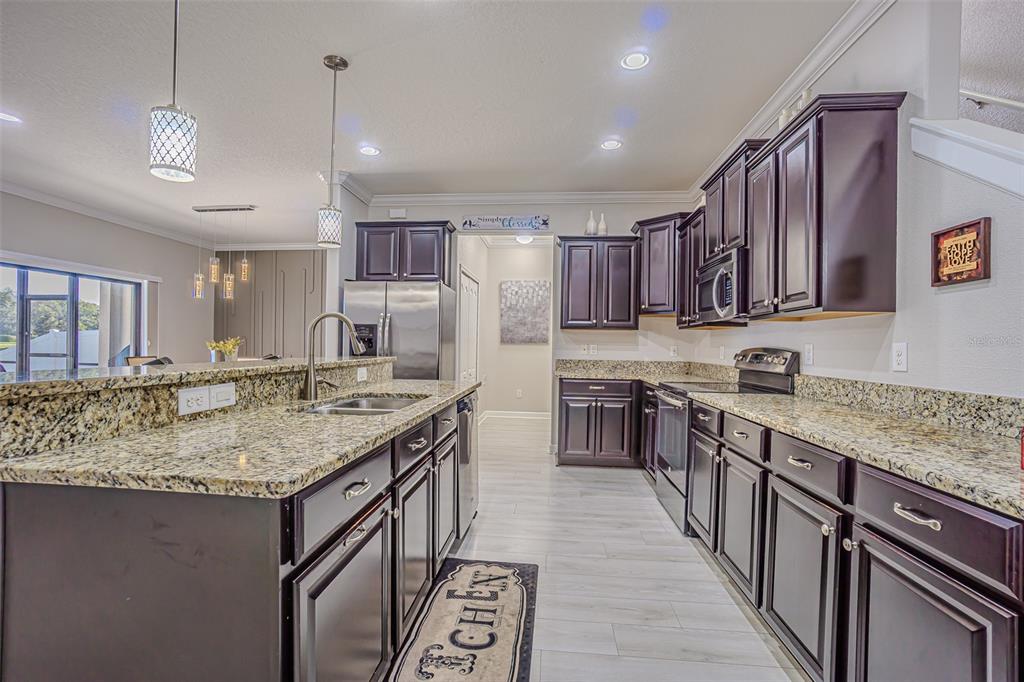 1762 Hadden Hall Place Trinity, FL 34655 - Photo 20 of 39 a kitchen with stainless steel appliances granite countertop a sink stove and cabinets