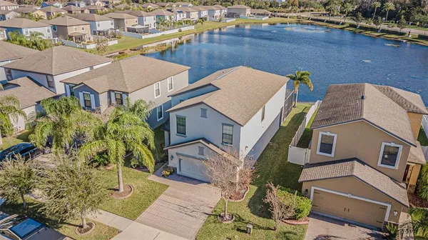 an aerial view of a house with a yard