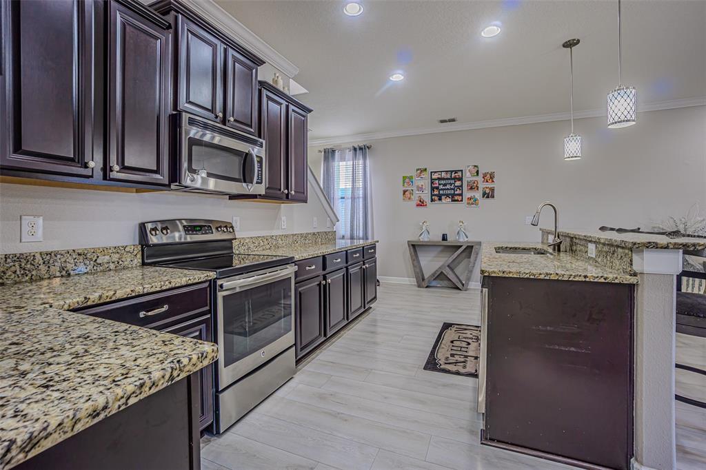 1762 Hadden Hall Place Trinity, FL 34655 - Photo 23 of 39 a kitchen with stainless steel appliances granite countertop a sink stove and cabinets