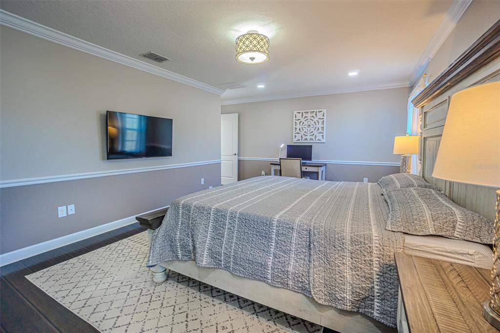 1762 Hadden Hall Place Trinity, FL 34655 - Photo 25 of 39 a bedroom with a bed and a flat screen tv