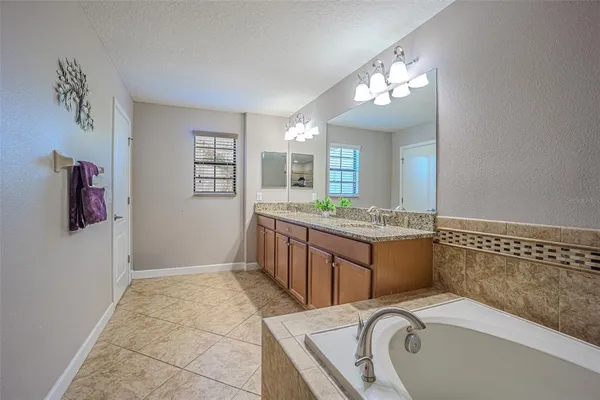 a bathroom with a sink vanity and a mirror