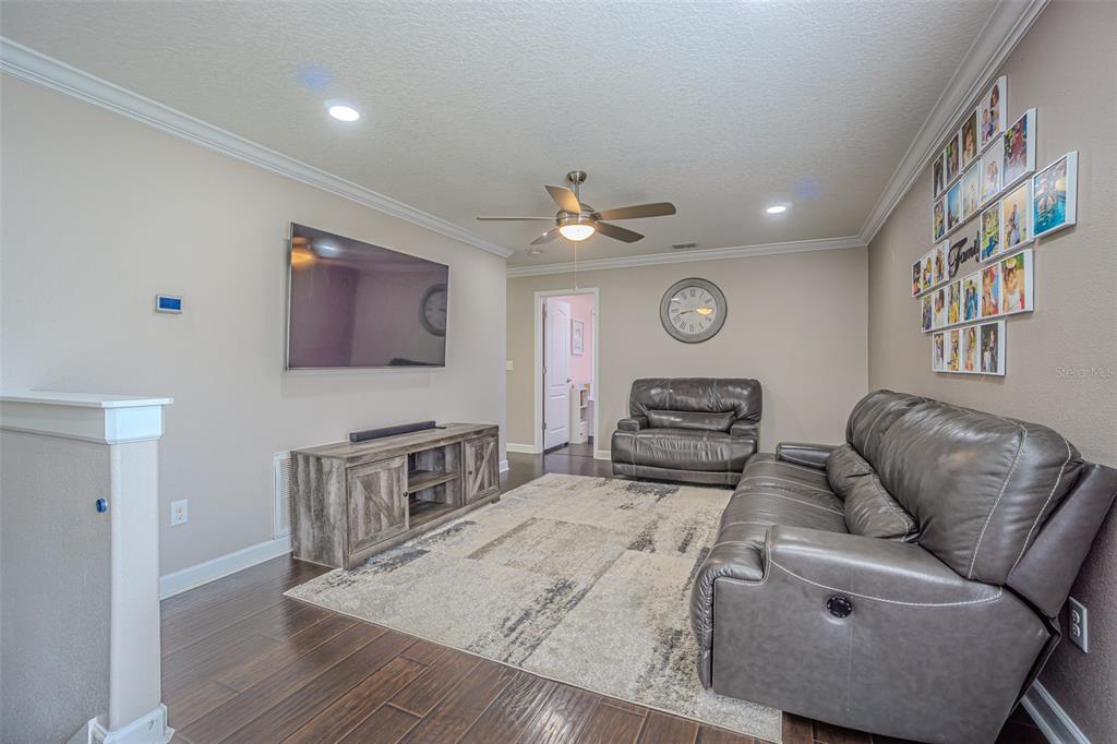 1762 Hadden Hall Place Trinity, FL 34655 - Photo 29 of 39 a living room with furniture and a wooden floor