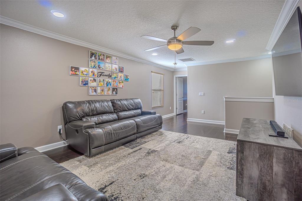 1762 Hadden Hall Place Trinity, FL 34655 - Photo 30 of 39 a living room with furniture and a chandelier
