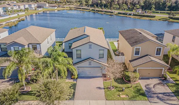 an aerial view of a house with a lake view