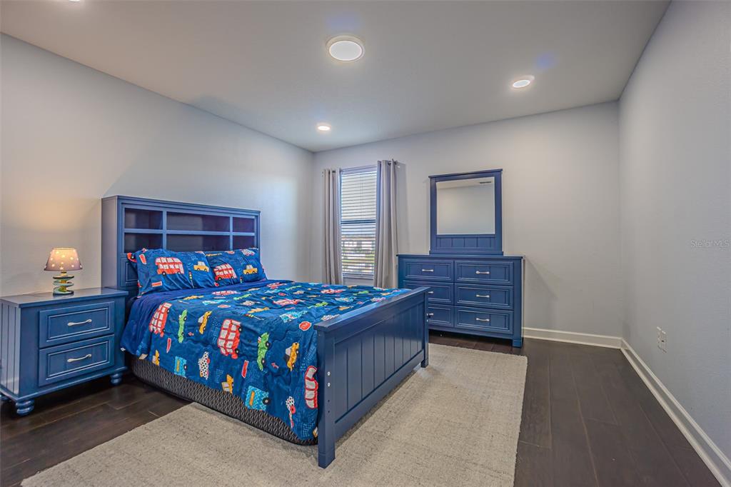 1762 Hadden Hall Place Trinity, FL 34655 - Photo 34 of 39 a bedroom with a bed and wooden floor