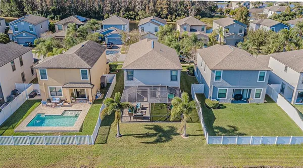 an aerial view of a house with a garden and swimming pool
