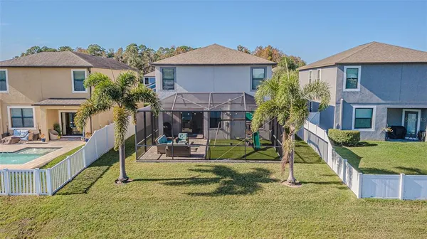 a patio with a table and chairs under an umbrella