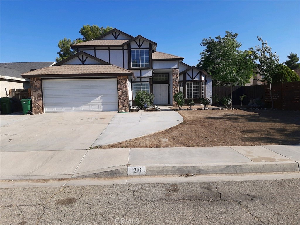 a front view of a house with a yard and a garage
