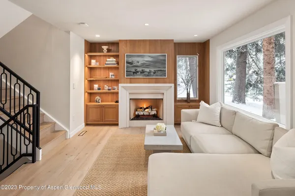 a living room with furniture and a fireplace