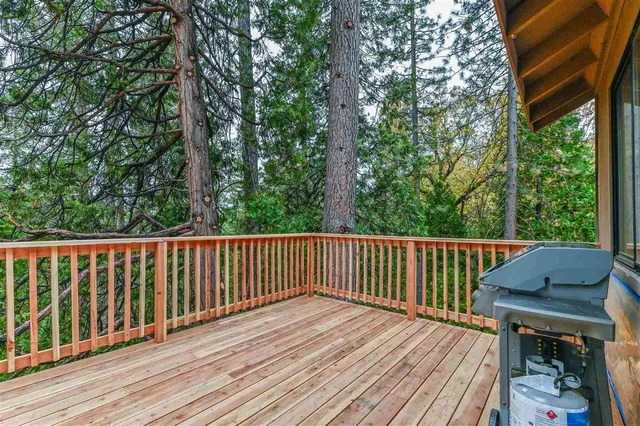 a balcony with wooden floor and outdoor space