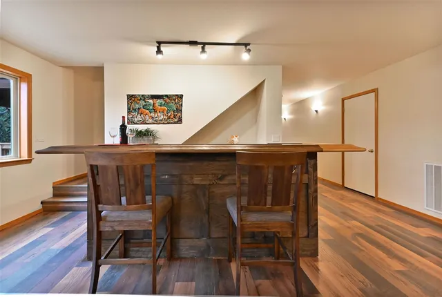 a view of a dining room with furniture and wooden floor