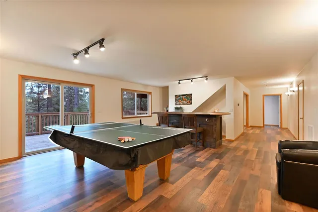a view of a livingroom with furniture wooden floor and windows