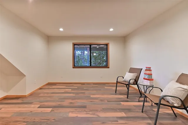 a view of workspace room with wooden floor and windows