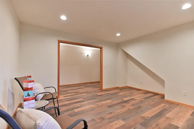 a view of a room with wooden floor and furniture