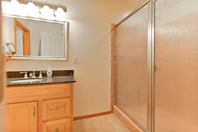 a bathroom with a sink a mirror and a shower