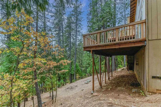 a view of balcony with wooden floor and fence