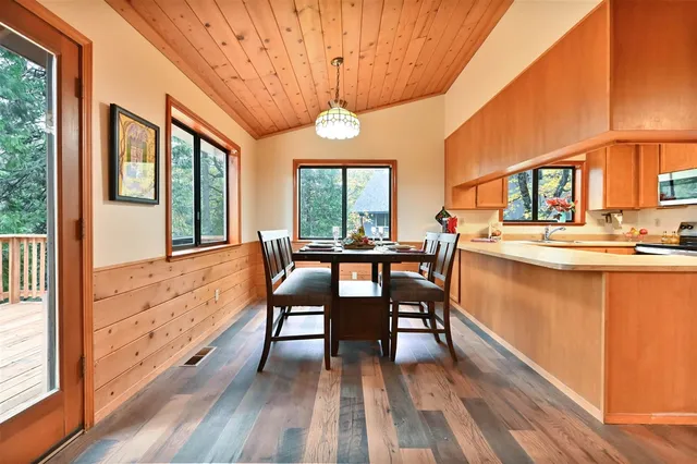 a dining room with furniture a chandelier and wooden floor